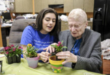 Beren Academy student Dina Kirshner and Medallion resident Marcene Goldman plant flowers