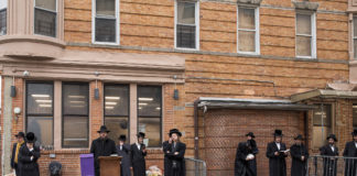 Hasidic men pray outside