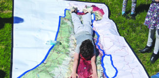 Beth Am students lie on a map of Israel