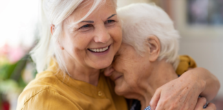 woman embraces elderly woman