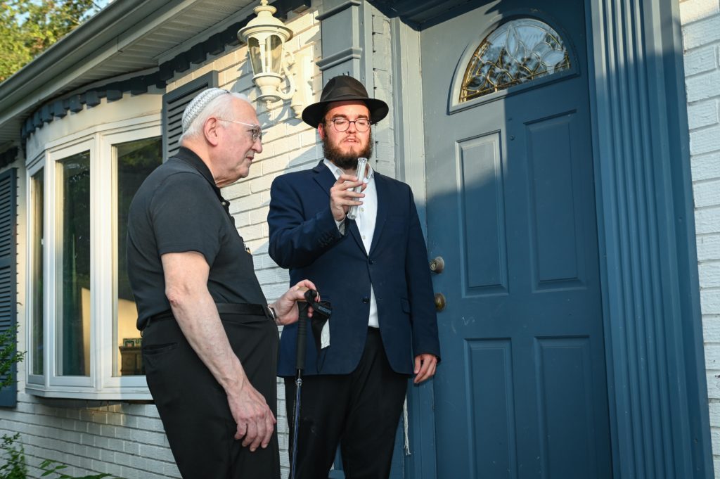 Dr. Jonathan Finkelstien (left) and Rabbi Yanky Baron affix a mezuzah on the new spiritual home of Chabad of Ellicott City 