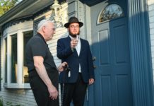 Dr. Jonathan Finkelstien (left) and Rabbi Yanky Baron affix a mezuzah on the new spiritual home of Chabad of Ellicott City