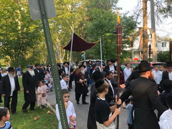 Members of Chabad of Park Heights celebrate the arrival of their new Torah scroll