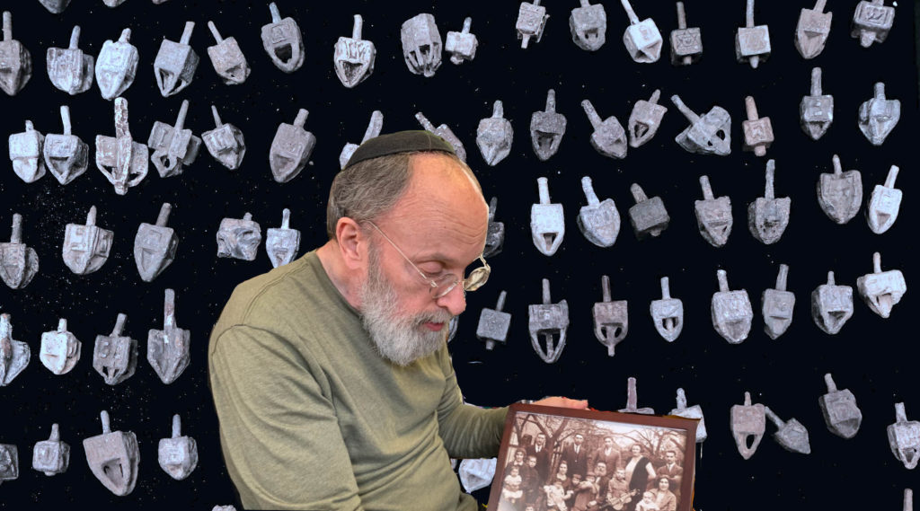 Arthur Kurzweil against a backdrop image of his dreidel collection