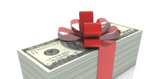 Stack of money wrapped with a bow