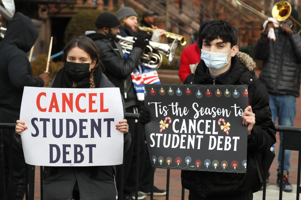 activists holding signs for student debt cancellation