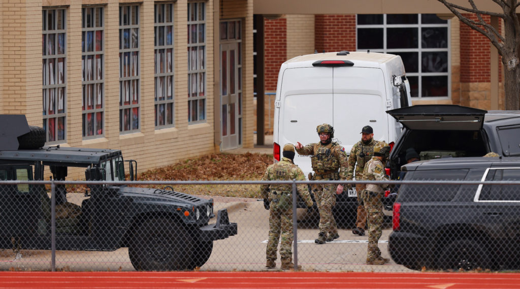 SWAT team members deploy near the Congregation Beth Israel Synagogue in Colleyville, Texas