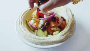 hummus topped with Greek salad