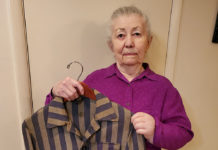Malwina Moses holds a concentration camp jacket