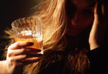 woman holding alcoholic beverage