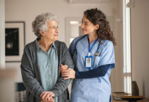 Caregiver helps senior woman