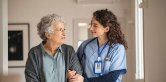 Caregiver helps senior woman