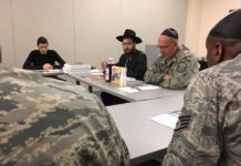Rabbi Chesky Tenenbaum (second from left) teaches Passover 101 at the Veterans Administration in a previous year