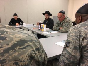 Rabbi Chesky Tenenbaum (second from left) teaches Passover 101 at the Veterans Administration in a previous year
