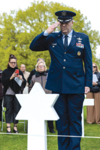 Colonel D. Gottrich salutes at Star of David gravestone