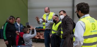 Rabbi Ari J. Goldstein (fourth from left) performs magic tricks for a child at a refugee center in Przemysl, Poland