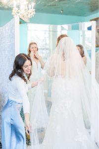 woman trying on wedding dress