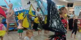 Flamenco dancers dancing with children