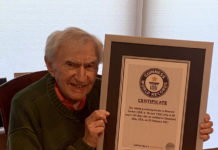 Dr. Howard Tucker holds the Guiness World Records certificate recognizing him as the oldest active physician in the United States.
