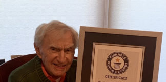 Dr. Howard Tucker holds the Guiness World Records certificate recognizing him as the oldest active physician in the United States.