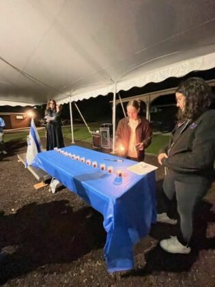 Teenager lights a candle.
