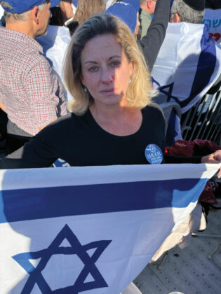 Ettie Goldstein holding an Israeli flag