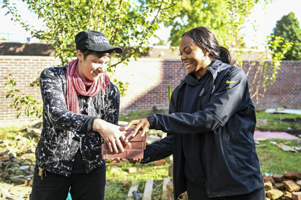 Repair the World volunteers work in a garden