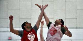 Two players jump for the opening tip at a basketball game at the University of Maryland