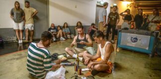 Three men sitting on the floor