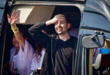 ‘Peeling Away the Layers of Damage’: Freed Hostages at Beilinson Hospital A man holding his hand to his head and a woman waving.