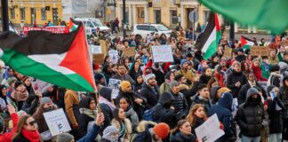 A group of people standing outside at a protest.
