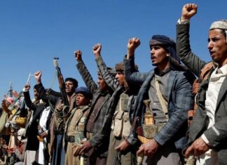 A group of men with their right arms raised.