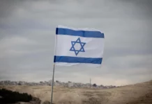 Sa’ar: No Sovereignty Over Judea and Samaria, ‘At Least in Coming Months’ A blue and white Israeli flag.