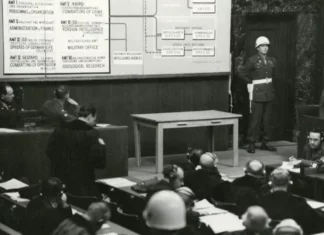 A black and white photo of an old courtroom scene.