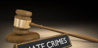 Sign that says "Hate Crimes" and a gavel