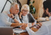 How to Create a Business Succession Plan: A Guide to Getting Started Financial advisor explaining paperwork to elderly retired couple front of desk